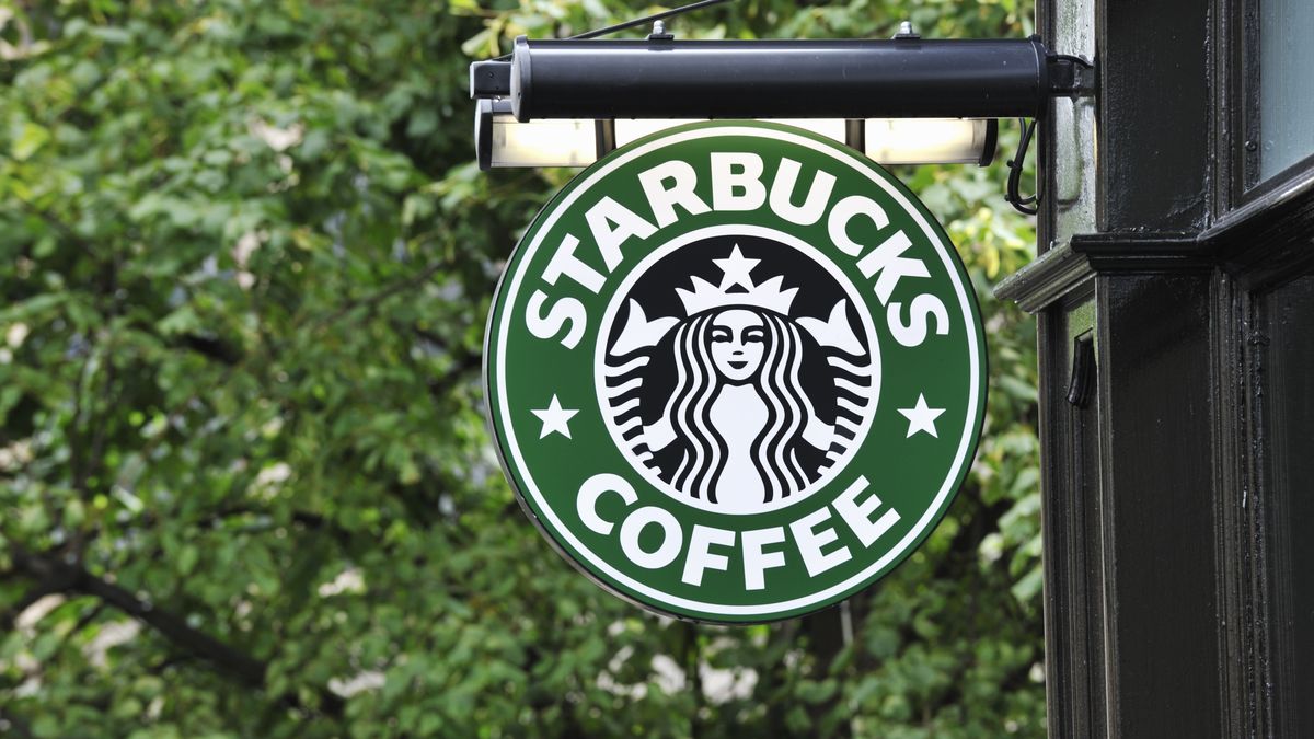 starbucks coffee sign hanging outside a shop