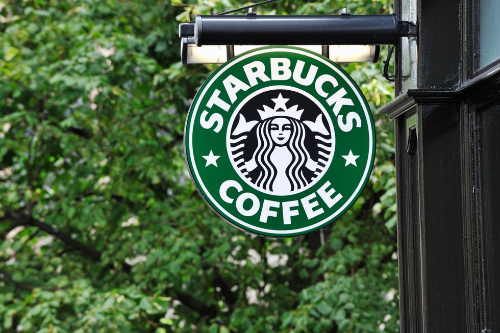 starbucks coffee sign hanging outside a shop