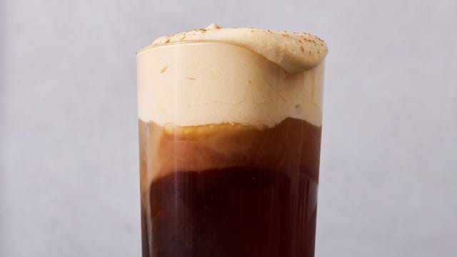 pumpkin cream with cinnamon on top of a glass of cold brew