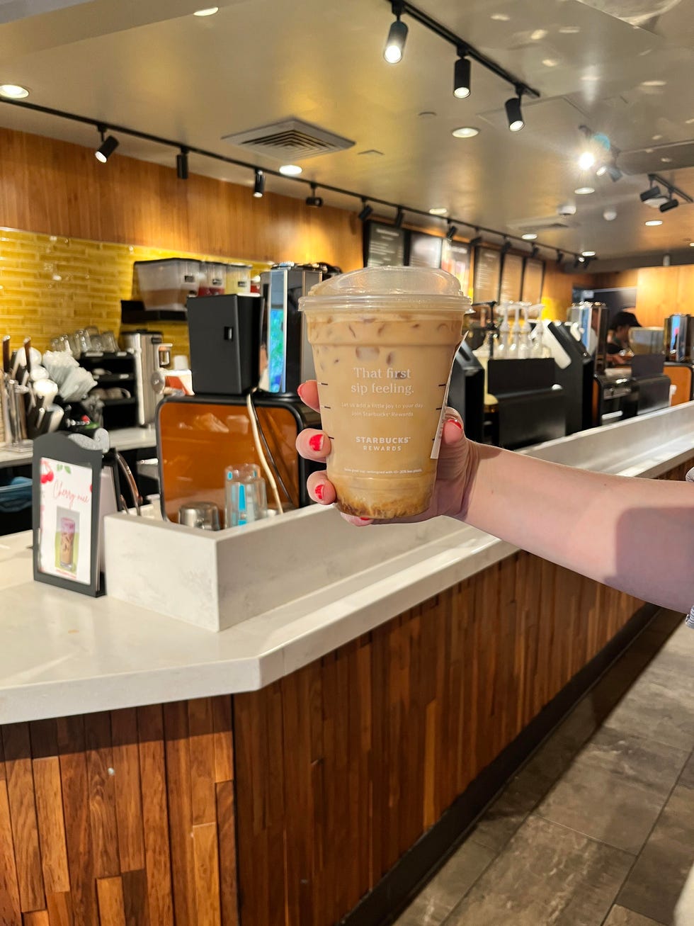 iced starbucks drink in front of starbucks counter