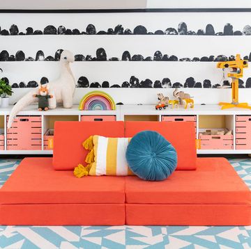 the nugget, an orange kids couch with two pillows on it, a good housekeeping pick for best kids couch