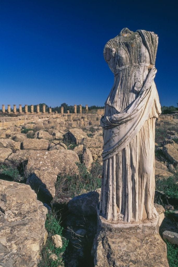 Female figure and ruins of houses, Cyrene