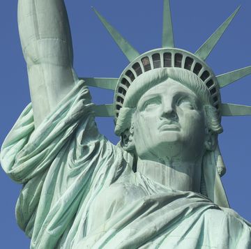 the statue of liberty on a clear day with blue skies
