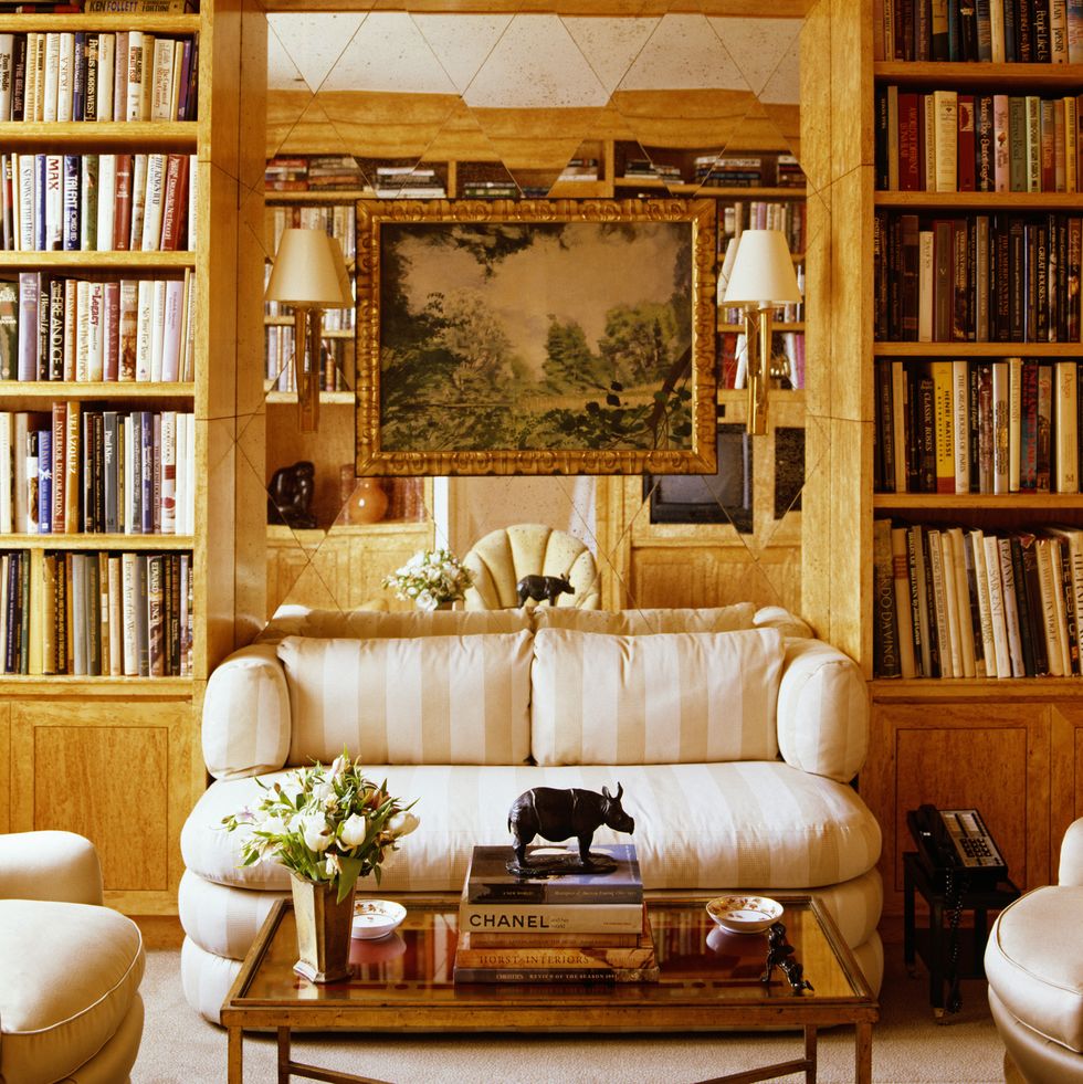 a statuette of a hippo is kept on the books on the center table in the living room