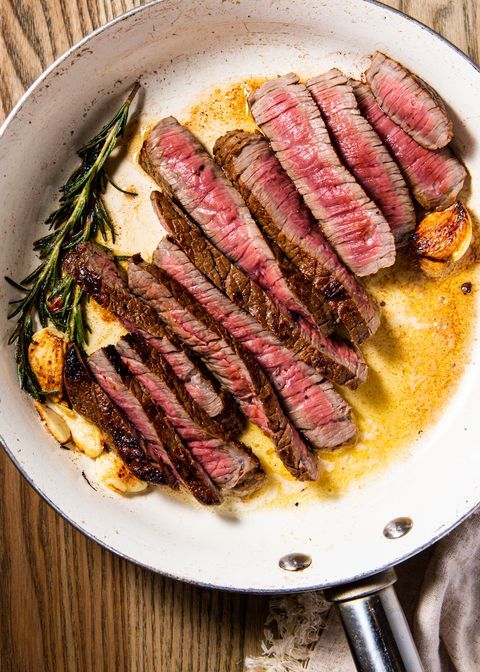 steak on a plate with rosemary and garlic