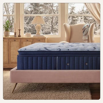 a cozy bedroom setting featuring a mattress on a stylish bed frame