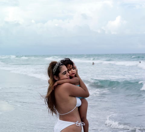 In Delray Beach Florida troost Amalia Suarez uit Fort Lauderdale haar teleurgestelde dochtertje van anderhalf Aliah Ze konden niet in zee gaan zwemmen omdat het water te onstuimig was Op een of andere manier gaat voor mij de magie van de zee verloren als er mensen zijn zegt fotografe Maggie Steber We kunnen het geruis van de golven niet horen noch een persoonlijke uitwisseling met de baarmoeder van de aarde aangaan Maar tijdens mijn verkenningen heb ik plekken langs de Atlantische kust ontdekt die ik nog nooit goed had onderzocht hoewel ik al twintig jaar in Miami woon Lees ook Neem een zonnebad op een van deze twintig topstranden in de wereld