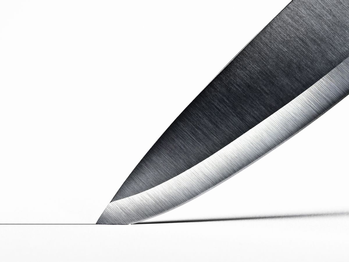 https://hips.hearstapps.com/hmg-prod/images/steel-knife-blade-cutting-into-surface-high-res-stock-photography-84428308-1540401323.jpg?crop=0.95207xw:1xh;center,top&resize=1200:*