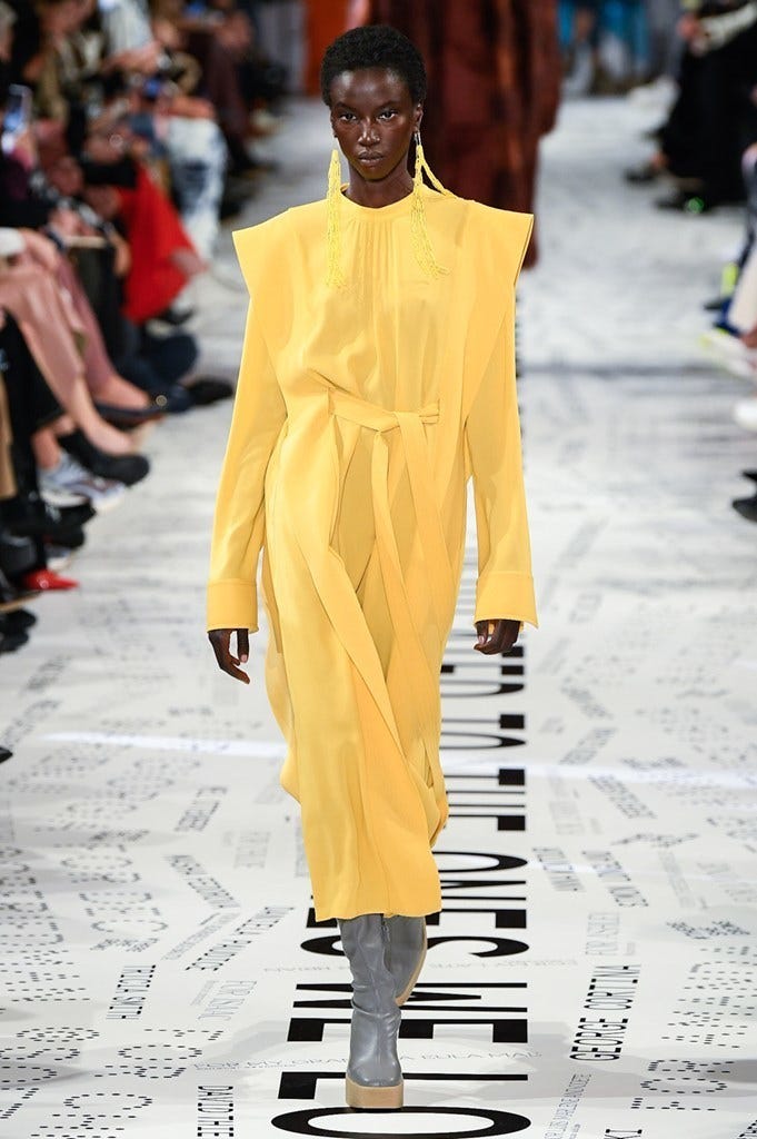 Fashion model, Fashion show, Fashion, Runway, Yellow, Street fashion, Human, Footwear, Fashion design, Outerwear, 