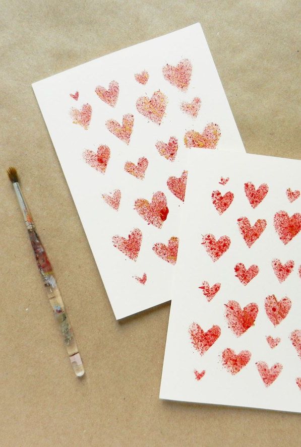 diy valentines day card idea with small red hearts of various sizes stencils on a white card