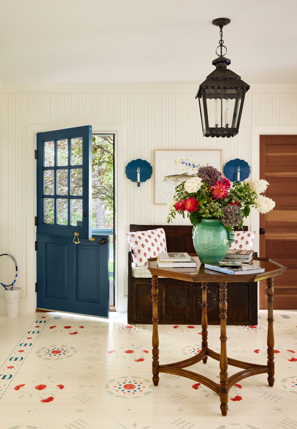 entry way with folk art motifs on the floor designed by lilse mckenna