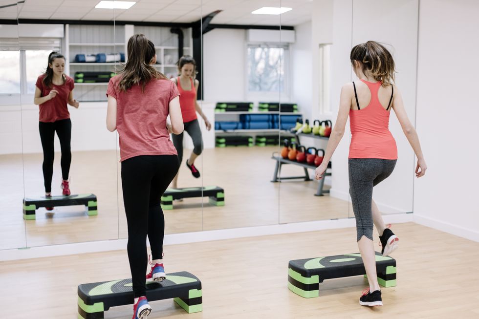 step aerobics class in an exercise studio