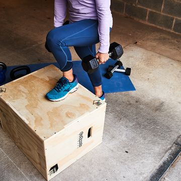 woman doing a rep of a step up with dumbbells, unit running injury