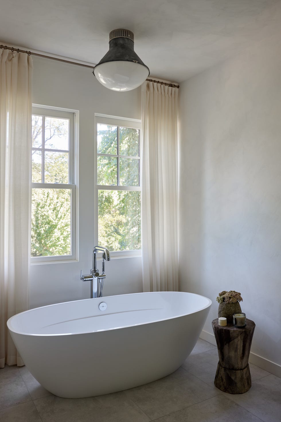 bathroom with soaking tub and wood side table