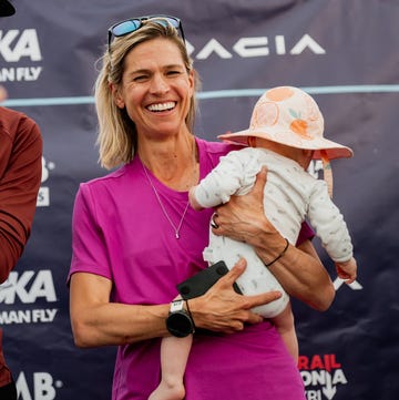a runner holding a baby a runner holding a baby