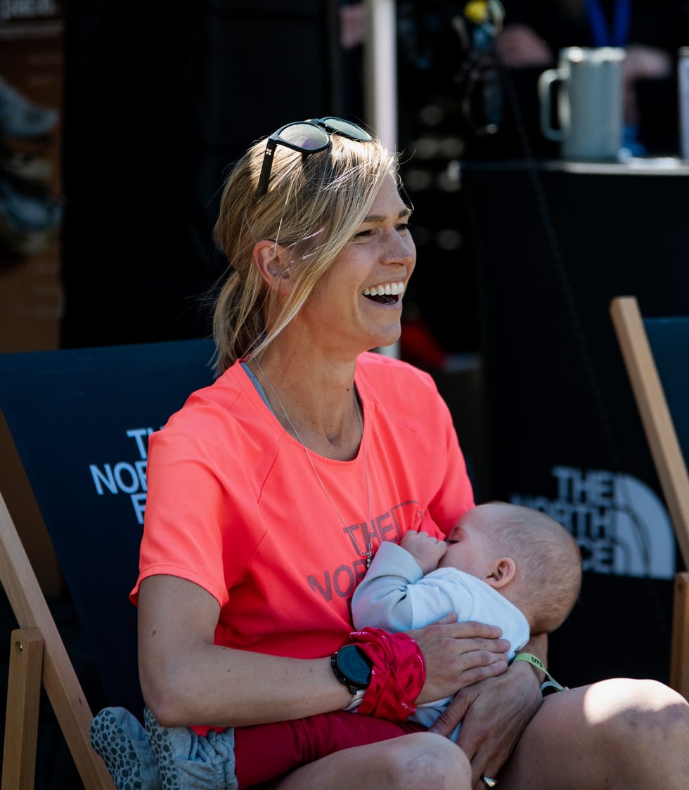 a runner holding a baby