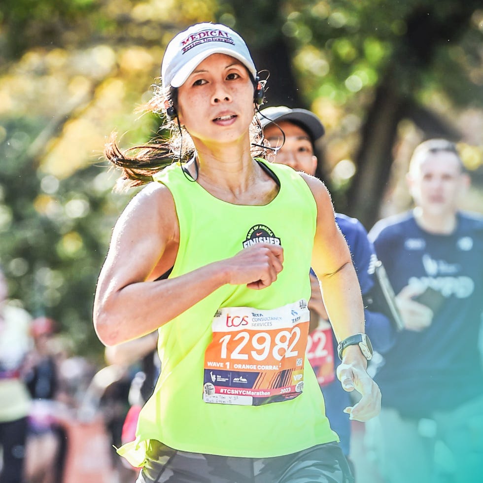 participant running in a marathon with a bib number and bright clothing