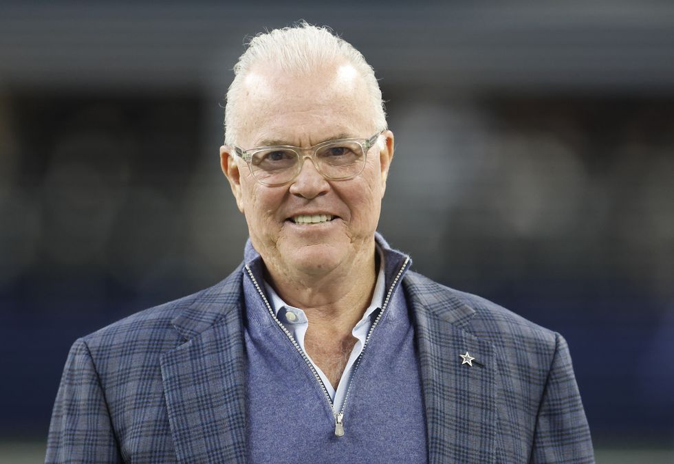 man in a blue vest and suit coat smiling