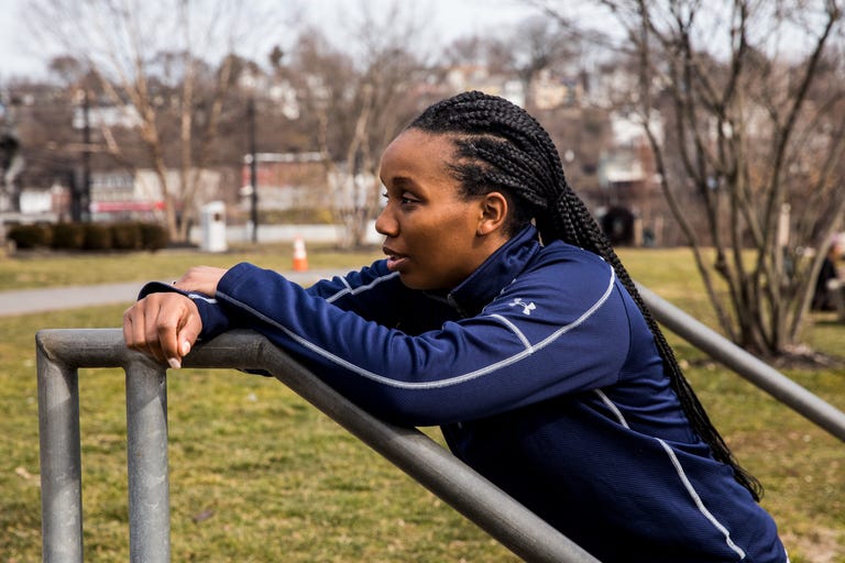 a runner leaning against a metal railing