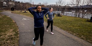 two runners walking on a path after a run