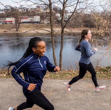 two women has running on a path by a body of water