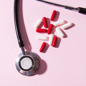 stethoscope and colorful capsule pills, with hard light and shadows