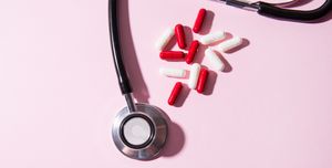 stethoscope and colorful capsule pills, with hard light and shadows