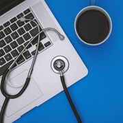 Stethoscope and Laptop on Blue Background