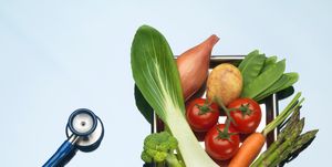 Stethoscope beside tray of fresh vegetables