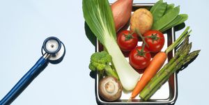 Stethoscope beside tray of fresh vegetables