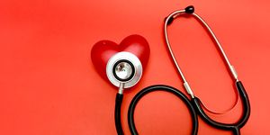 stethoscope  on red heart sing object on red background