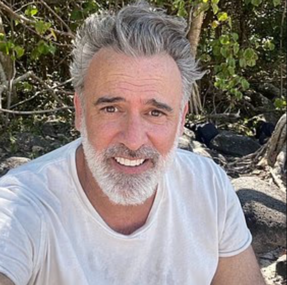 person sitting outdoors among rocks and greenery