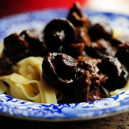 beef stew with mushrooms over pasta