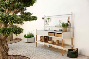 a patio garden with an outdoor kitchen