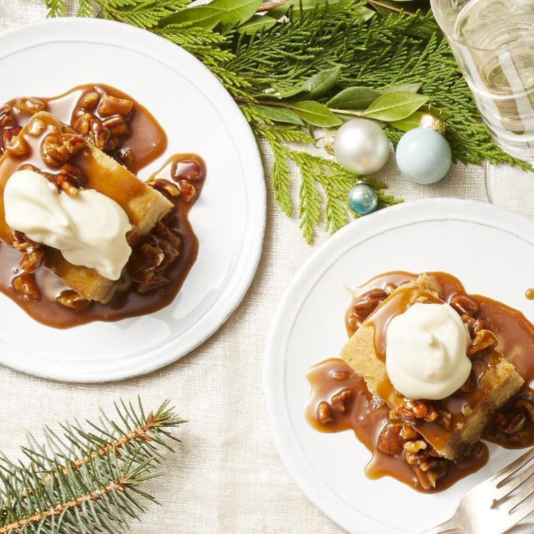 christmas foods   a pair of sticky toffee puddings on white plates