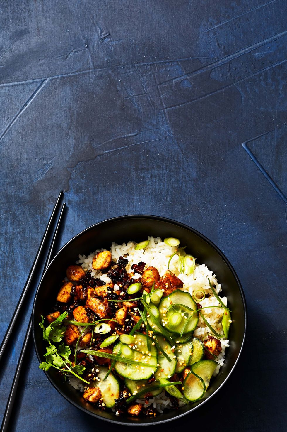 sticky tofu, veggies and rice in a bowl with chopsticks