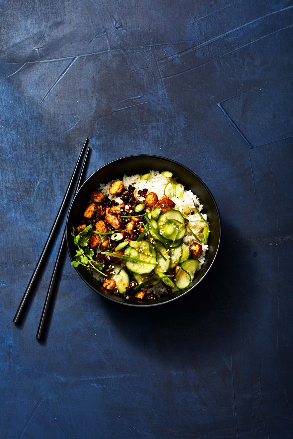 sticky tofu bowl with cucumber, white rice, scallions and more