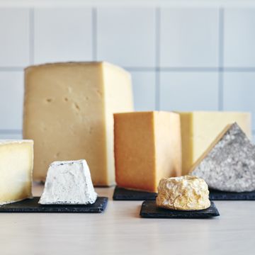 still life of a range of cheeses on table top