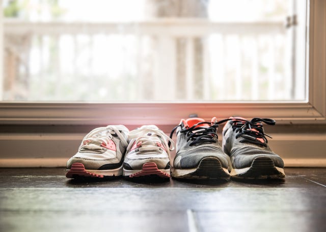 still life of different size shoes on floor at home