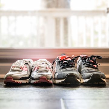 still life of different size shoes on floor at home