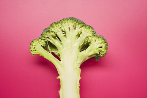 Still life of sliced broccoli on pink background