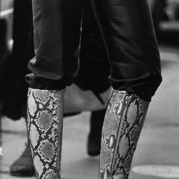 knee length fashion boots in a patterned design legs only visible photo by evening standardgetty images