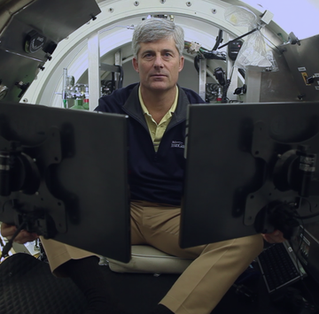 OceanGate CEO Stockton Rush man sitting in a submersible with computers all around him