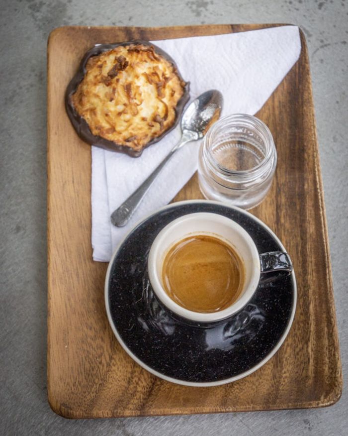 espresso in black espresso cup and scone
