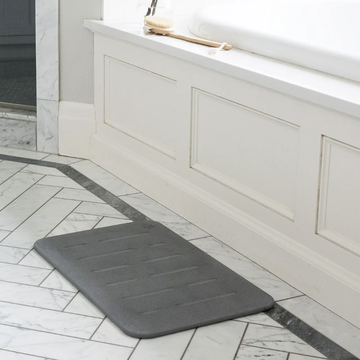 stone bath mats, gray stone bath mat on the bathroom floor by the tub