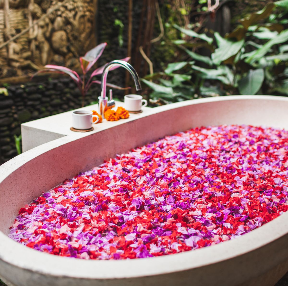 https://hips.hearstapps.com/hmg-prod/images/stone-bath-tub-full-of-flower-petals-in-balinese-royalty-free-image-1667849494.jpg?crop=0.671xw:1.00xh;0.0721xw,0&resize=1200:*