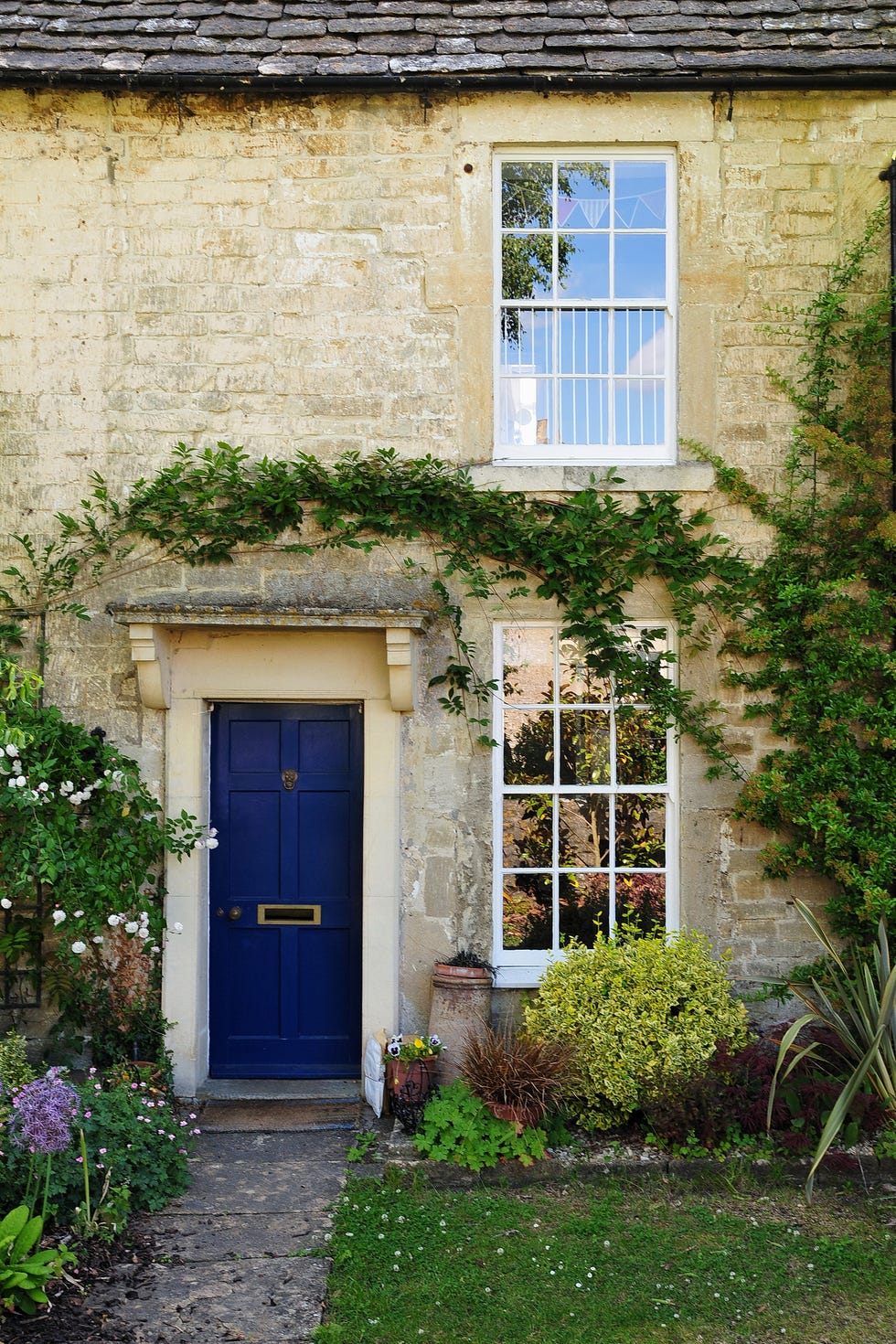 front garden ideas stone cottage with windows and blue door