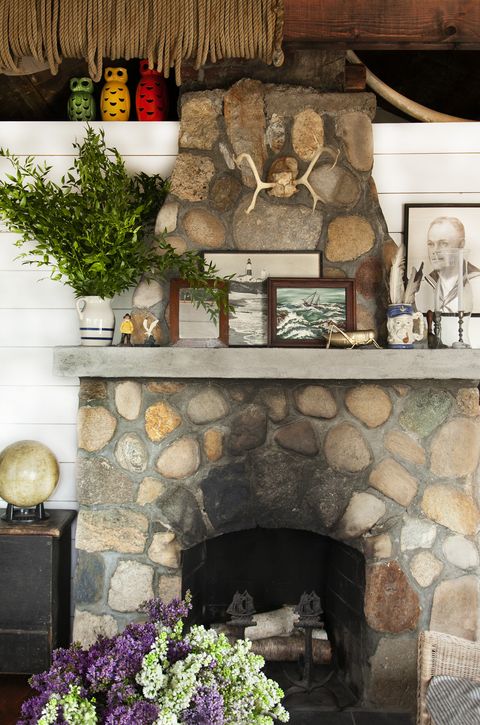 stone fireplace with collection of seascapes