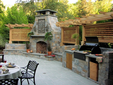 stone dining set and fireplace in outdoor kitchen ideas