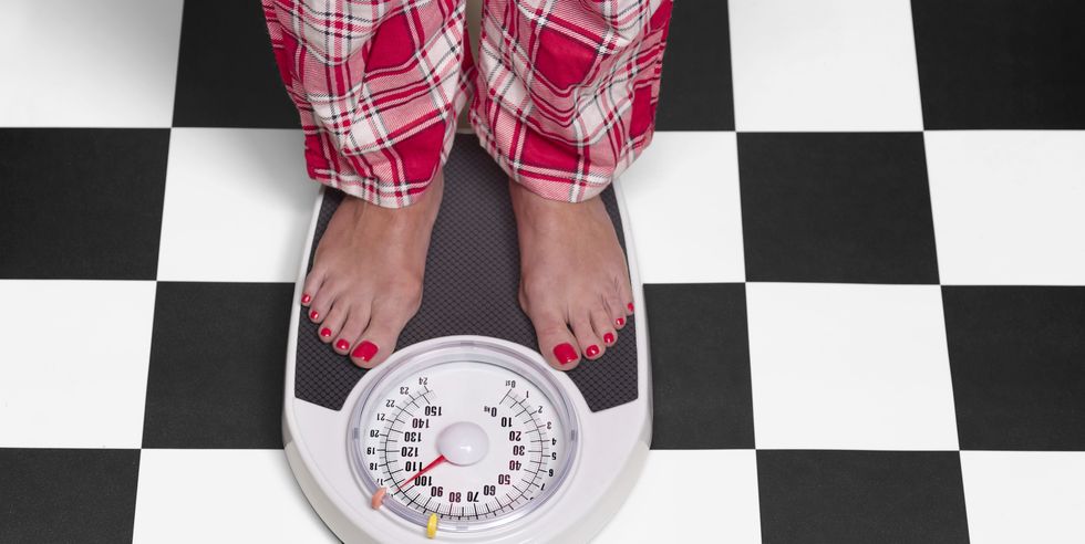 15 stone overweight woman on bathroom scales